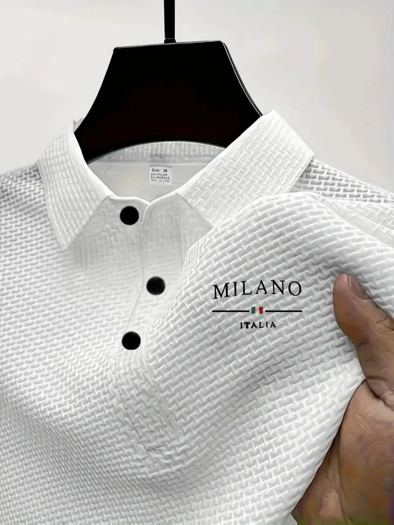 Men's short-sleeved white textured polo shirt with black buttons; Milano Italia logo on chest