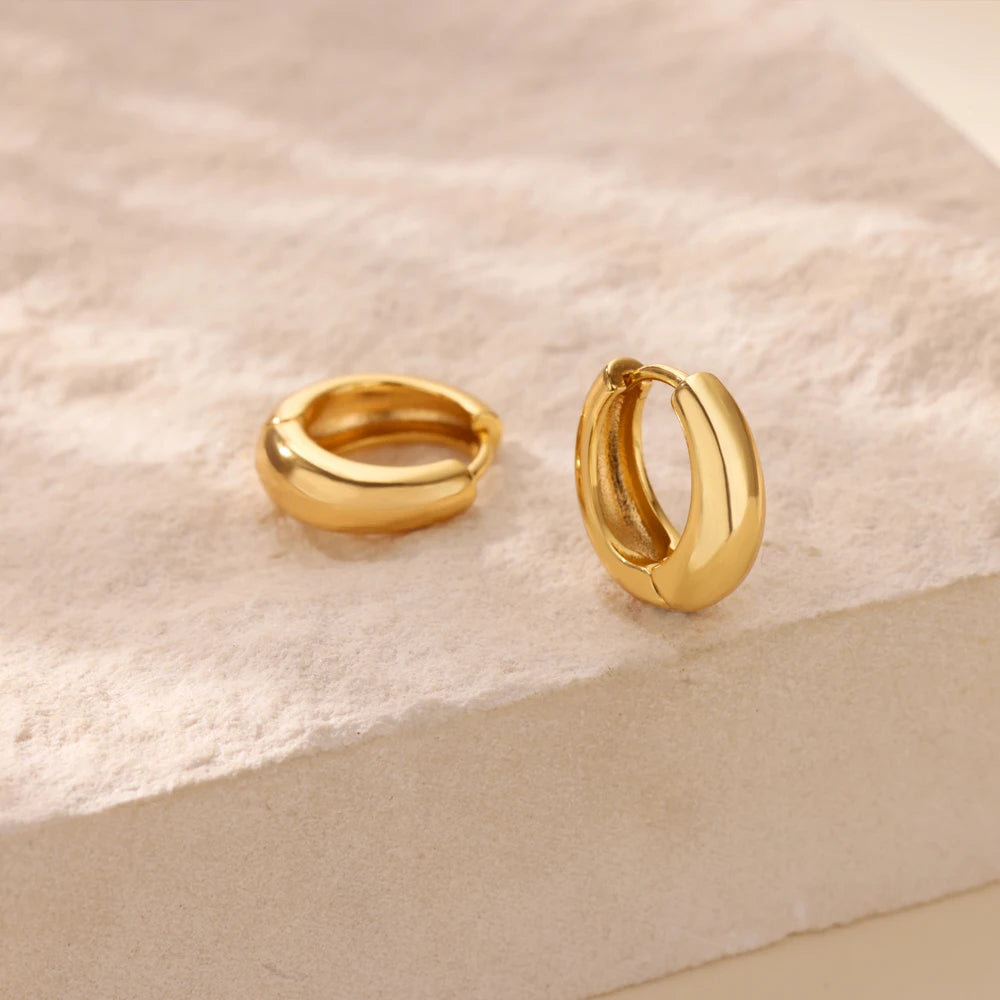Pair of gold-tone chunky hoop earrings for women in minimalist style
