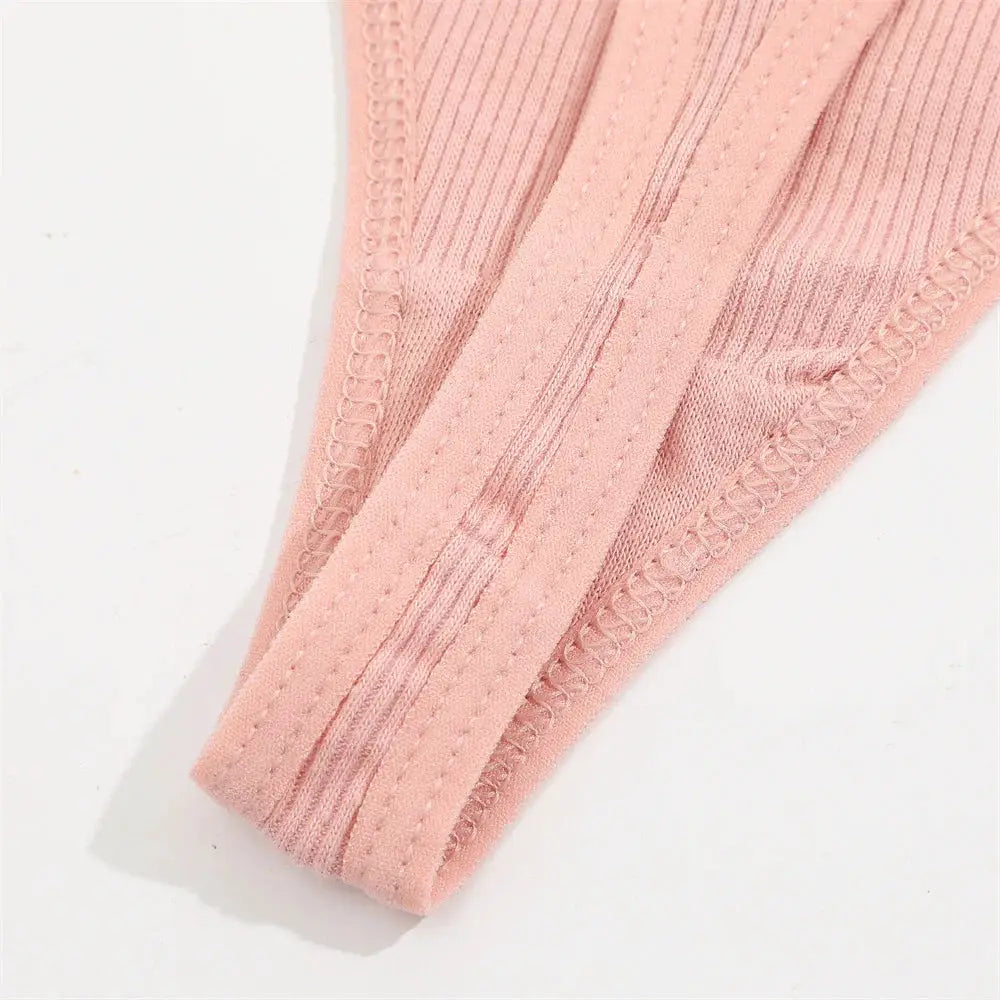 Women's pink cotton lace panties close-up showing soft knit fabric and ribbed waistband