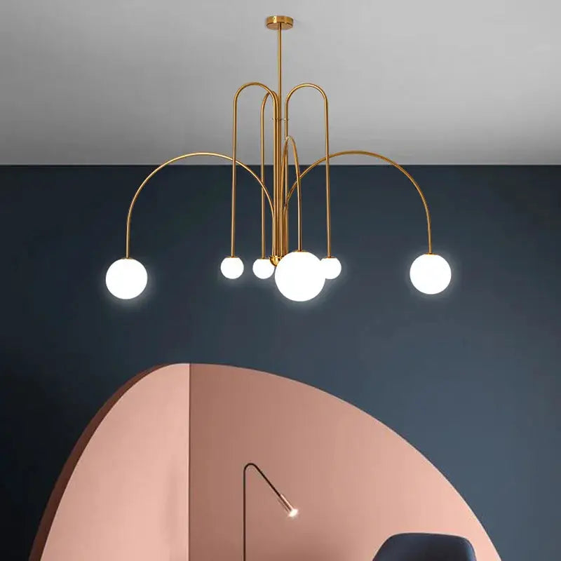 Nordic minimalist gold pendant light with multiple curved arms and white globe bulbs.
