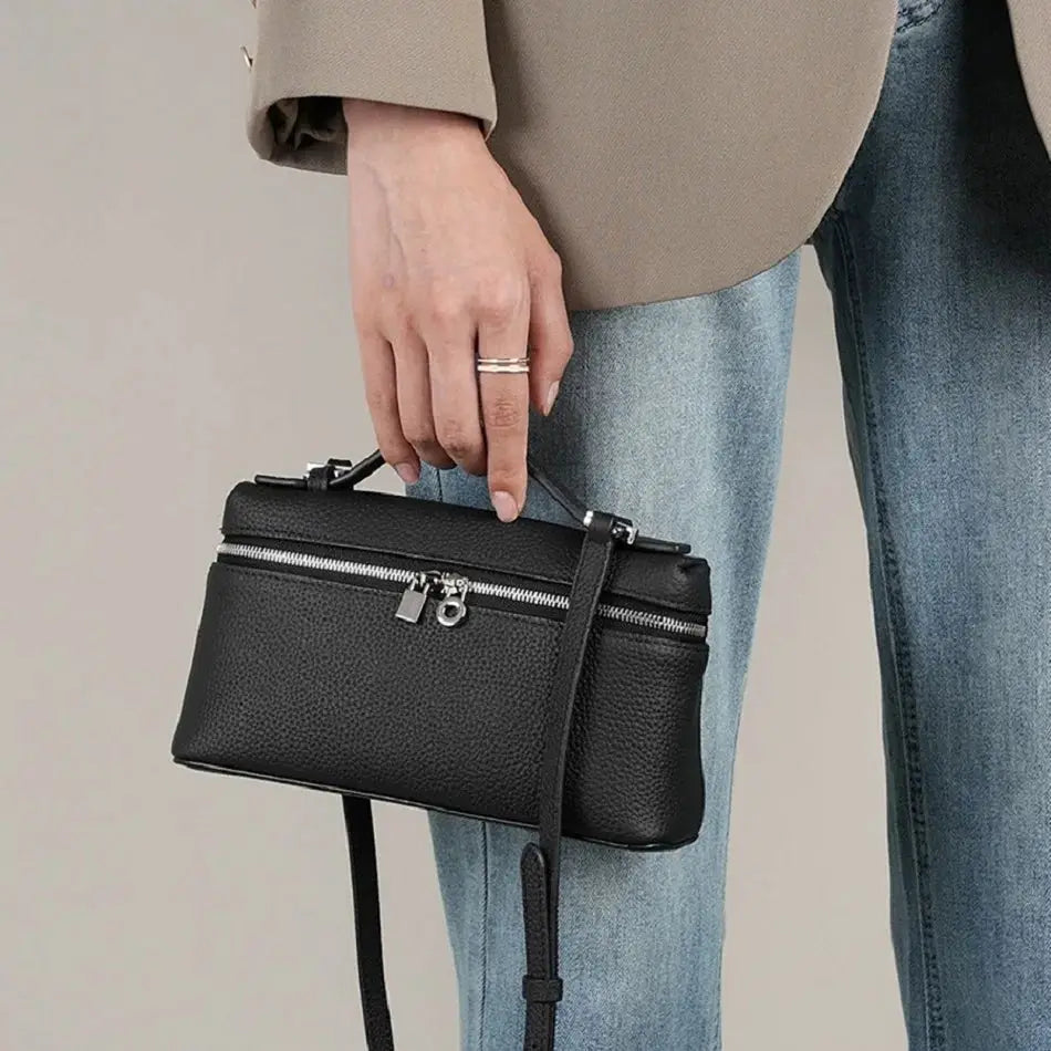 Mini black pebbled leather crossbody bag with top handle and silver zipper