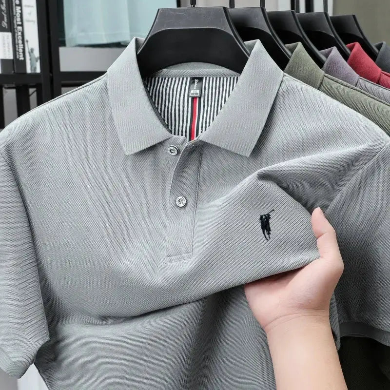 Grey polo shirt on hanger, 100% cotton with small black pony embroidery on chest