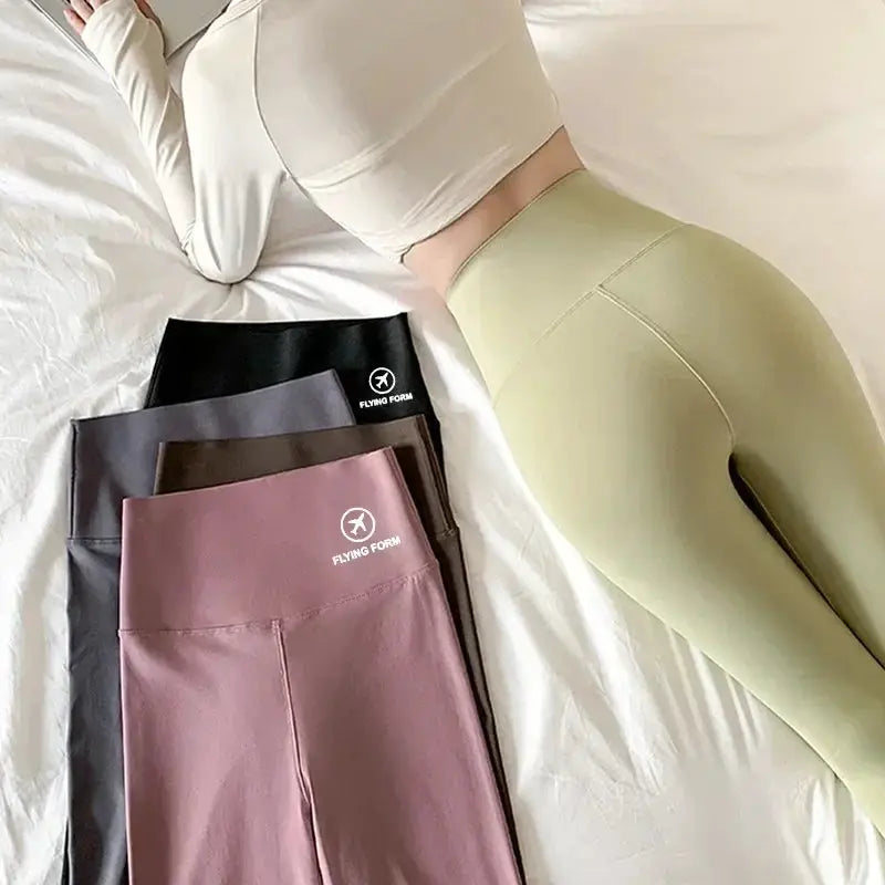 Shark pants women yoga leggings, high-waisted belly-lift, Flying Form logo, model wearing green with multi-color set
