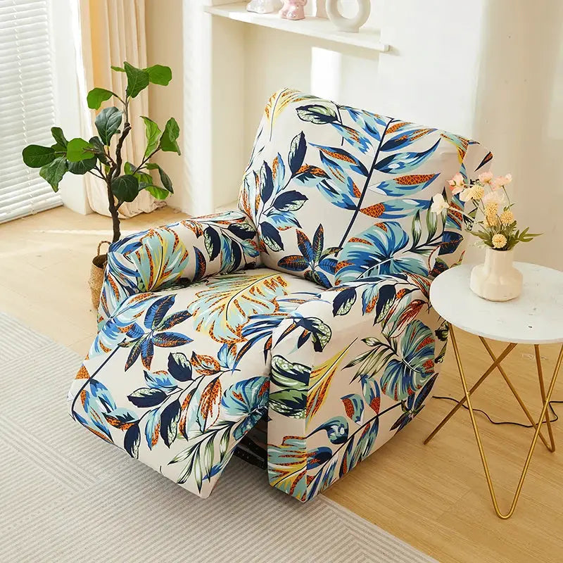 Recliner cover with tropical floral print; blue and orange leaves on white stretch fabric