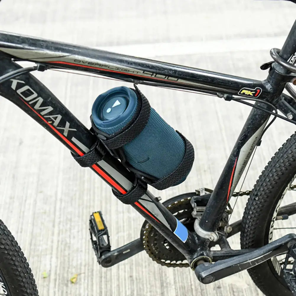 Speaker holder mount for bike with blue cylindrical device secured by Velcro straps