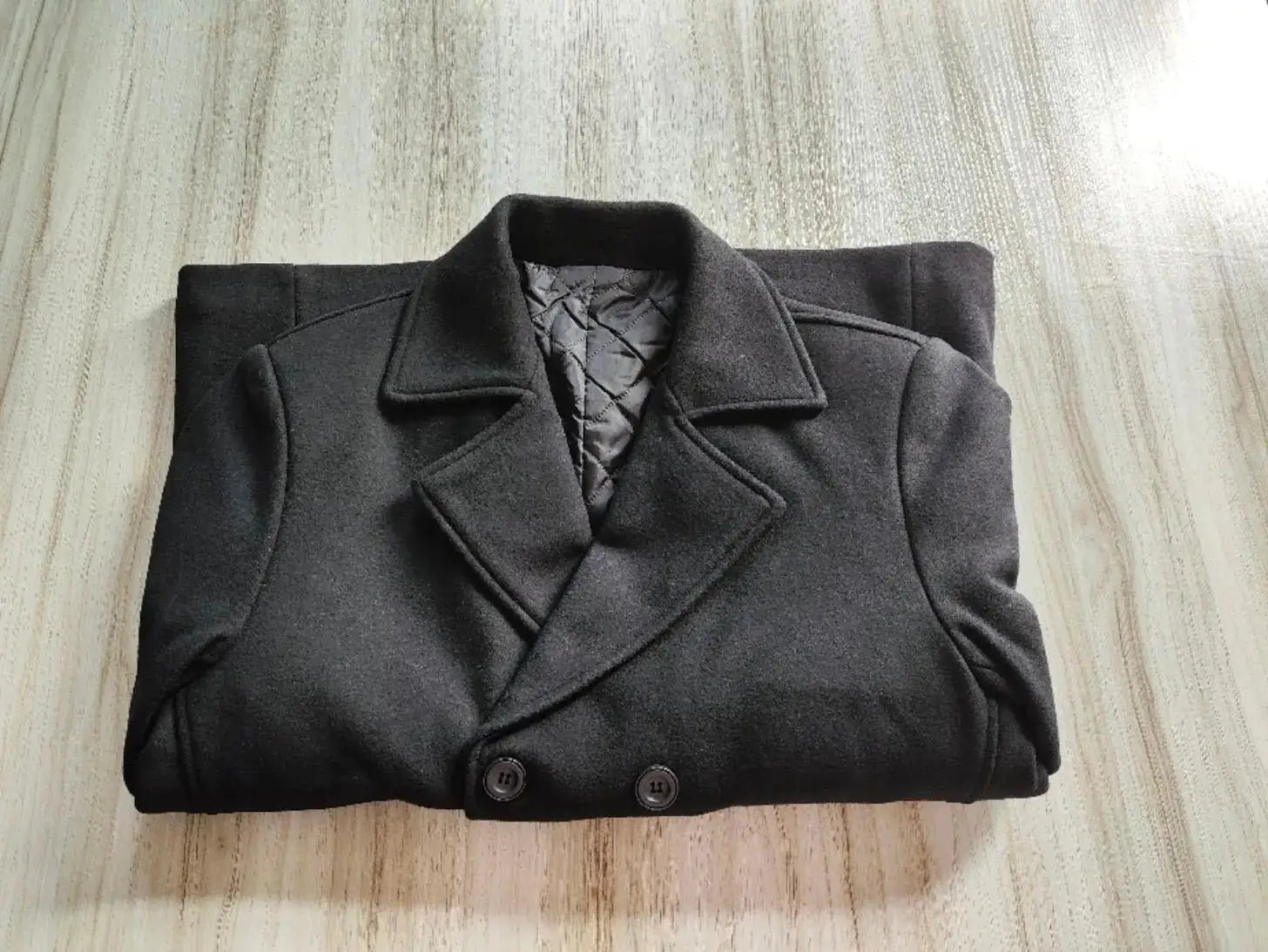 Men's black double-breasted wool coat with quilted inner lining