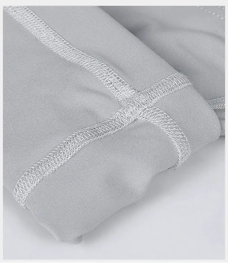 INBIKE men's cycling bib shorts fabric close-up in light grey with reinforced seam stitching.