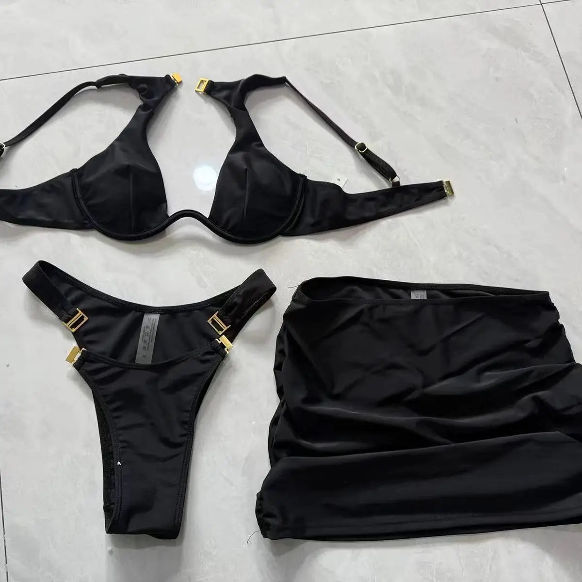 Simples Market black 3-piece bikini set with push-up top, high-cut bottom, and matching cover-up skirt