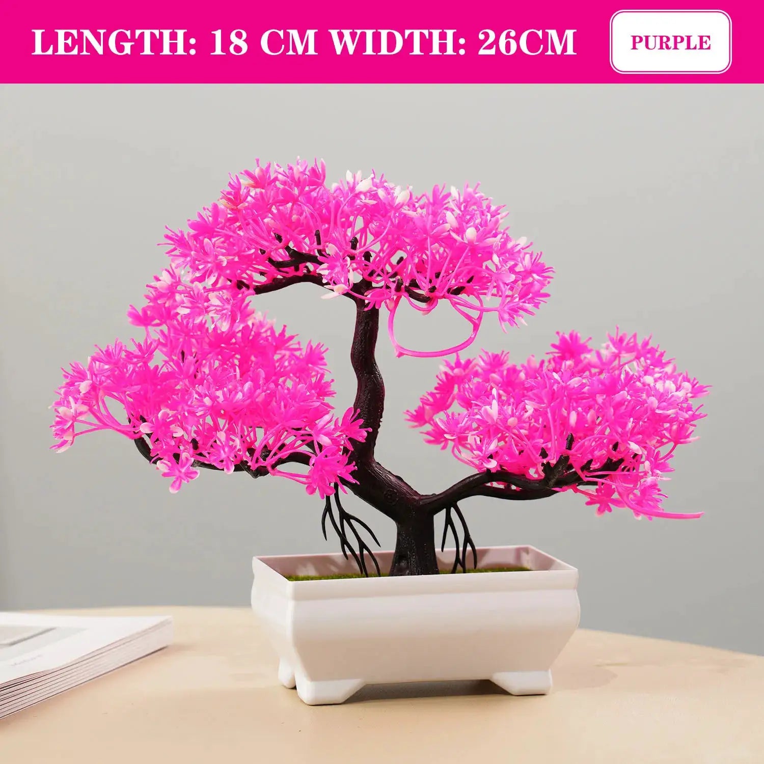 Artificial pink bonsai tree in a white ceramic pot; compact tabletop home decor.