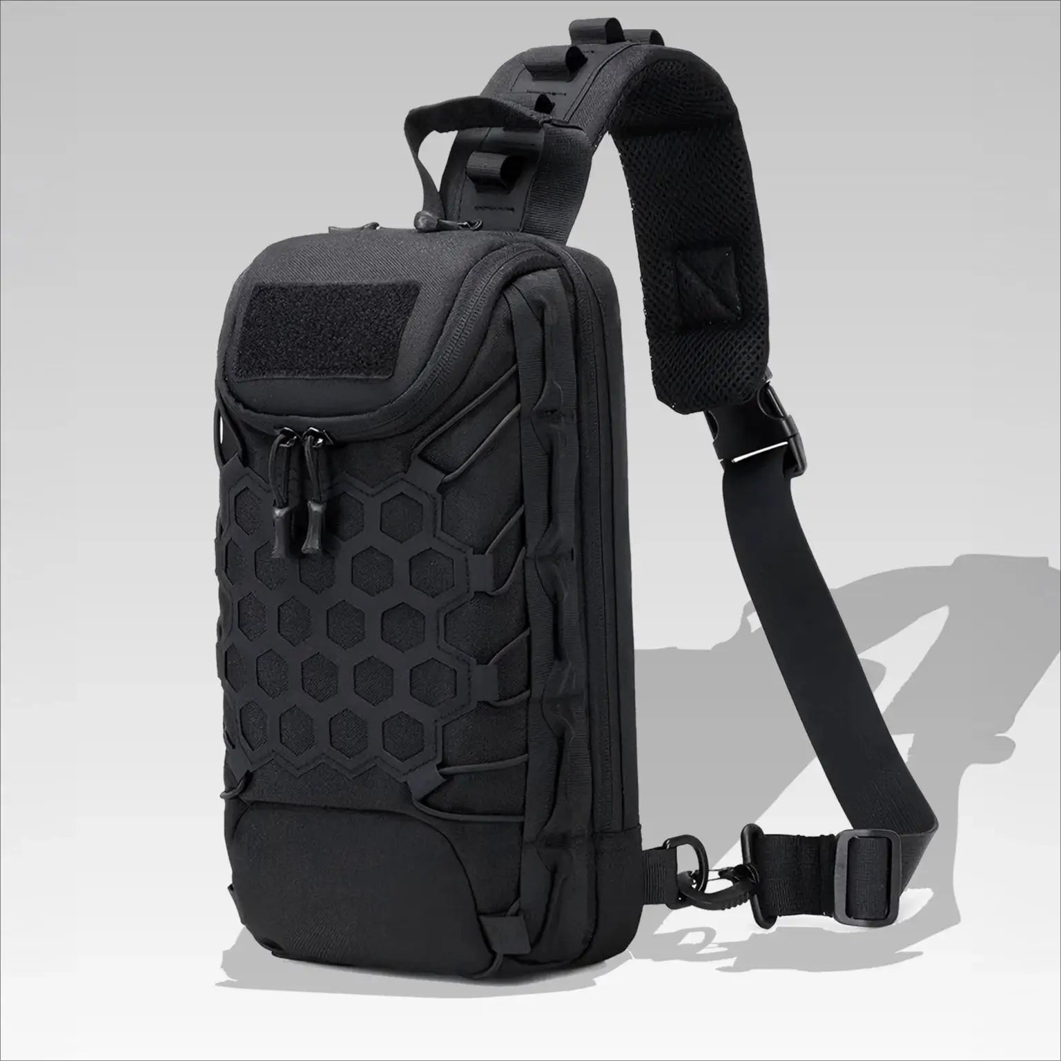 Outdoor Port Bag Pack tactical backpack sling in black with hex-pattern front and padded shoulder strap.