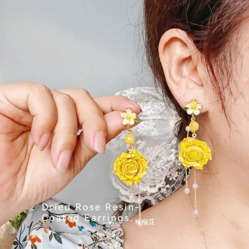 Pair of long yellow rose epoxy resin earrings with dangling bead accents
