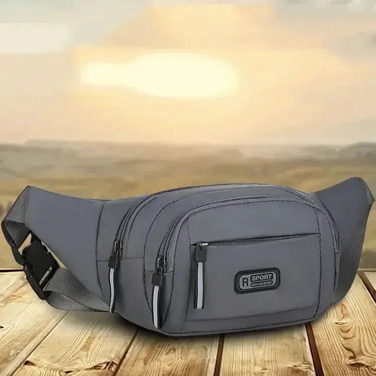 Men's gray canvas waist pack with multiple zip pockets and adjustable strap