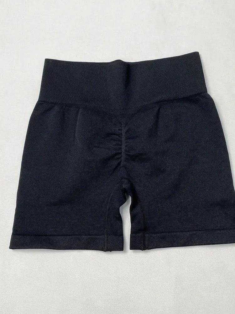 Women's high-waisted black yoga shorts with seamless hip-lifting design
