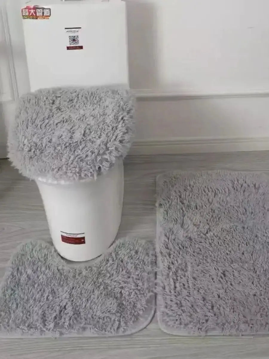3-piece bathroom rug set in grey fluffy fabric: U-shaped rug, toilet lid cover, and floor mats