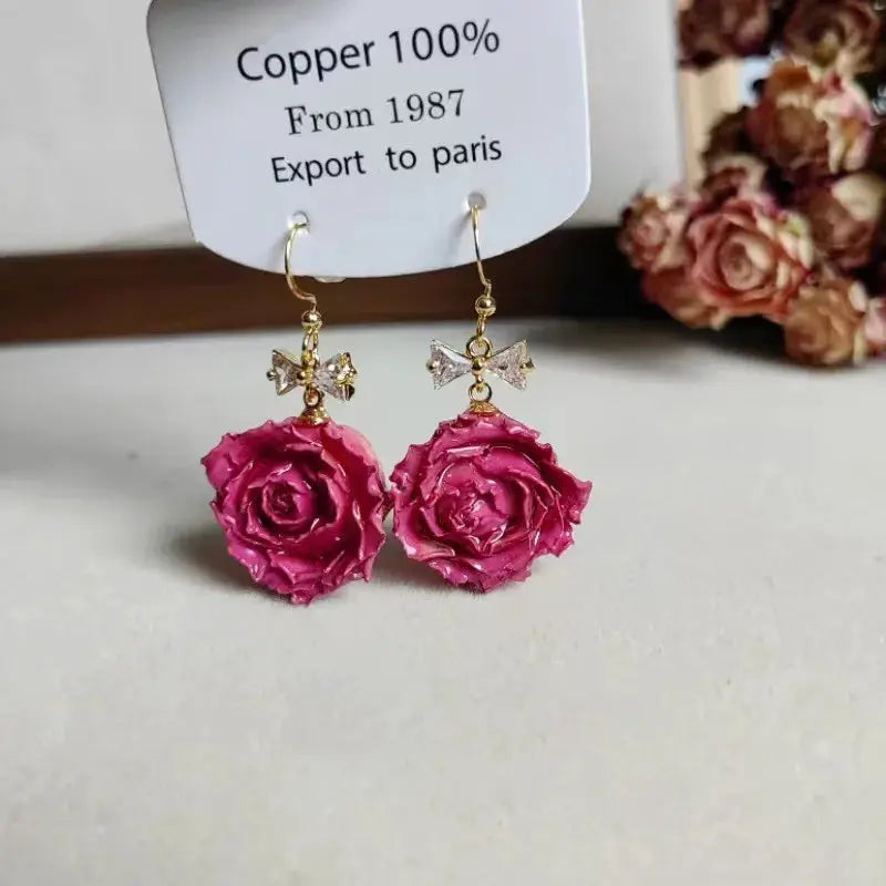 Rose flower earrings pair; pink epoxy rose drops with gold hooks and crystal bow accents