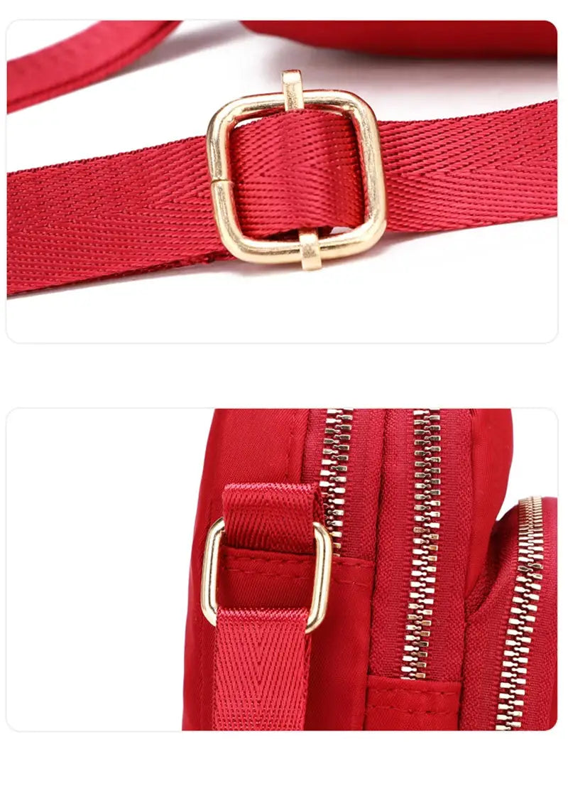 Women’s red waterproof crossbody bag with adjustable strap and gold-tone buckle hardware.