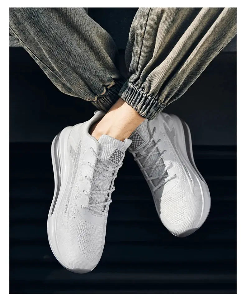 Men's white-gray mesh sneakers with breathable knit upper and cushioned sole.