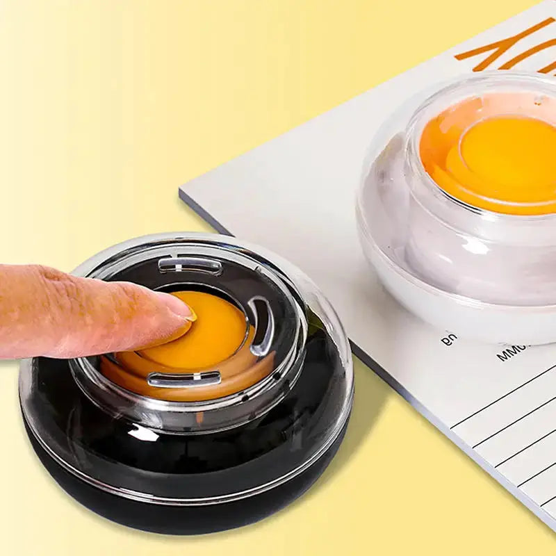 Finger-wet money-counting tool; round silicone pad on black base with orange top, 2-pack