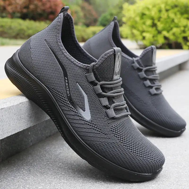 Pair of men's dark gray knitted running shoes, lightweight, breathable, non-slip sole.