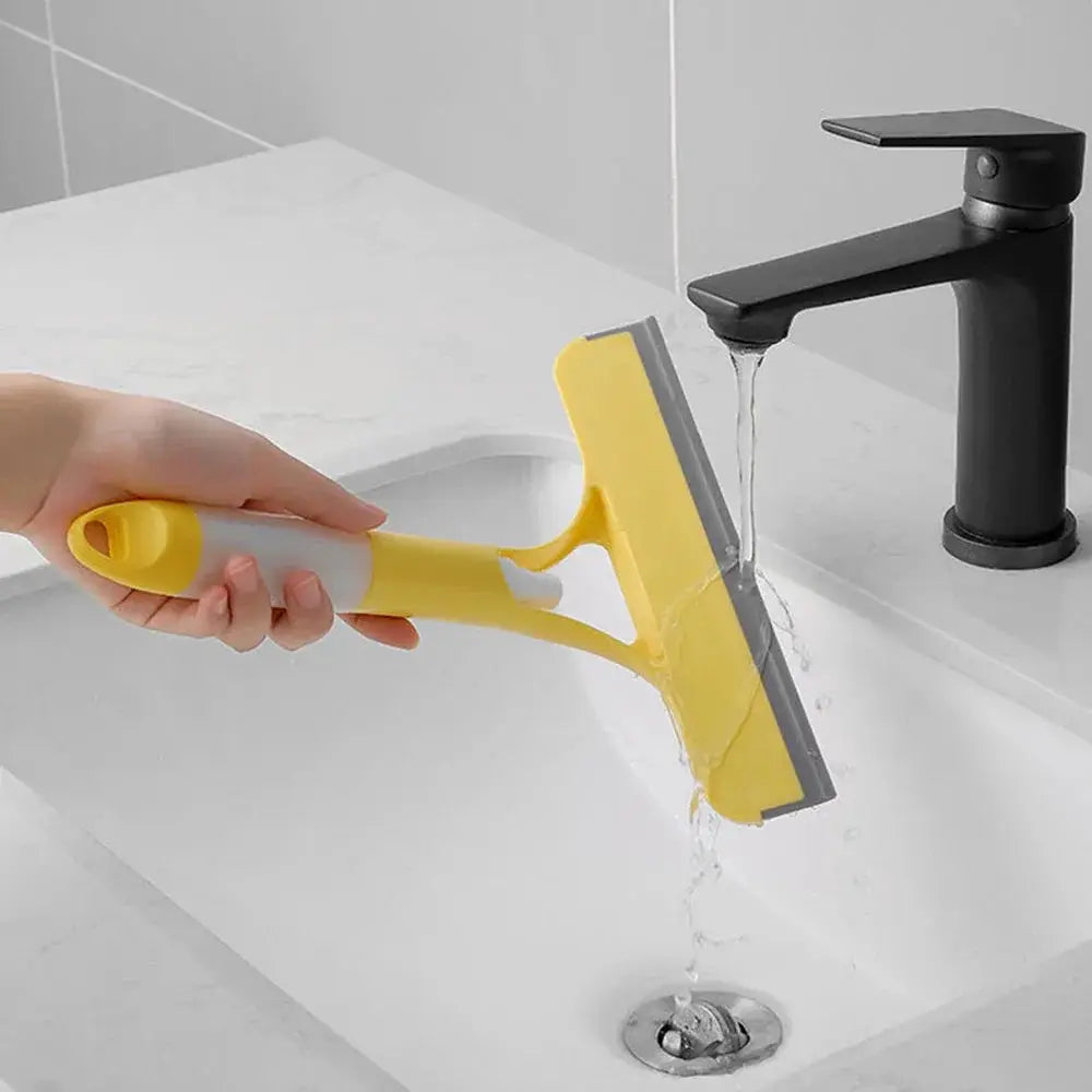 Yellow window cleaning squeegee with handle and rubber blade for glass and mirrors.