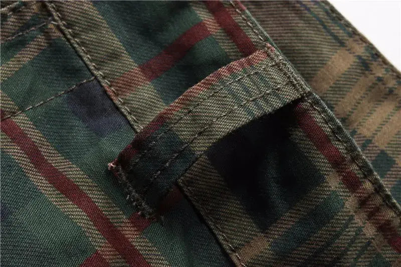 Men's plaid shorts fabric close-up in green, brown and red tones