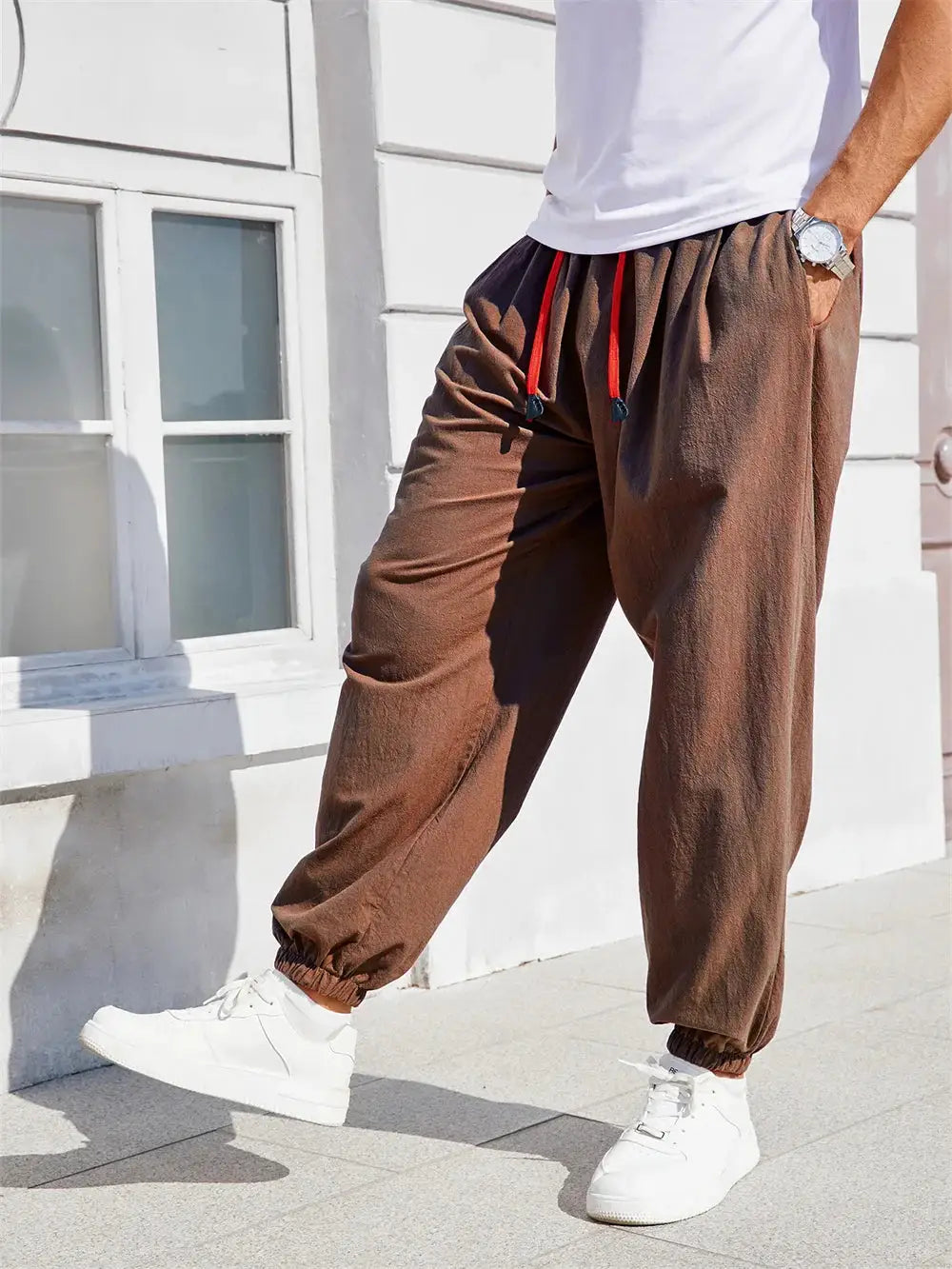 Men's loose-fit harem pants in brown cotton-linen with red drawstring, casual joggers