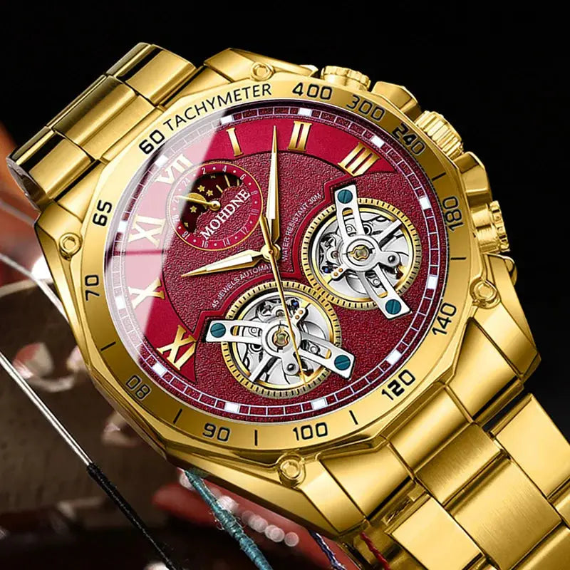 Gold-toned men's luxury quartz watch with red decorative dial, dual skeleton subdials, and tachymeter bezel.