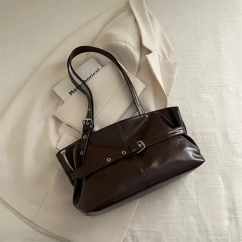 Leather handbag with belt buckle strap in dark brown, soft glossy leather, double top handles