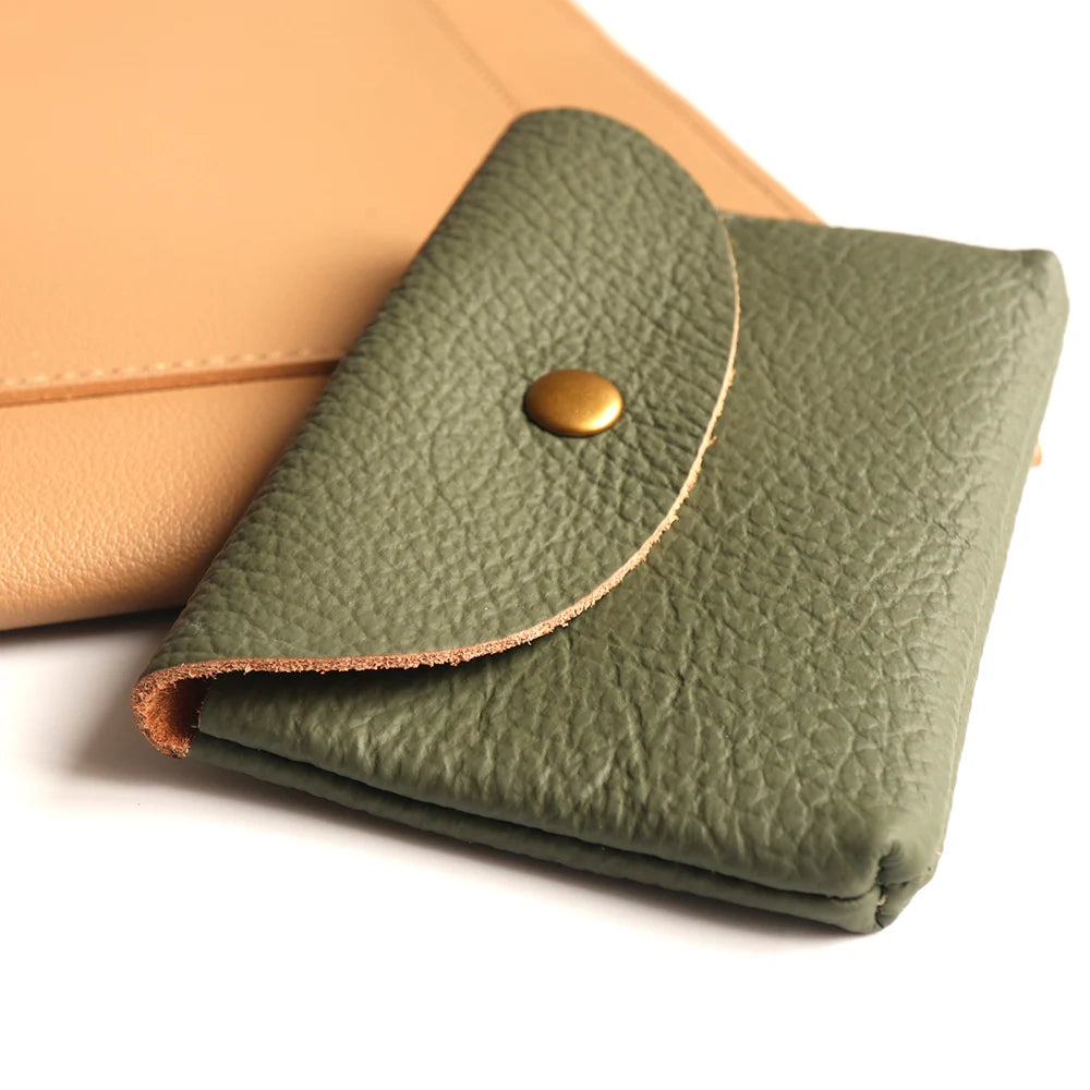 Leather card holders, two in green and tan, with brass snap flaps