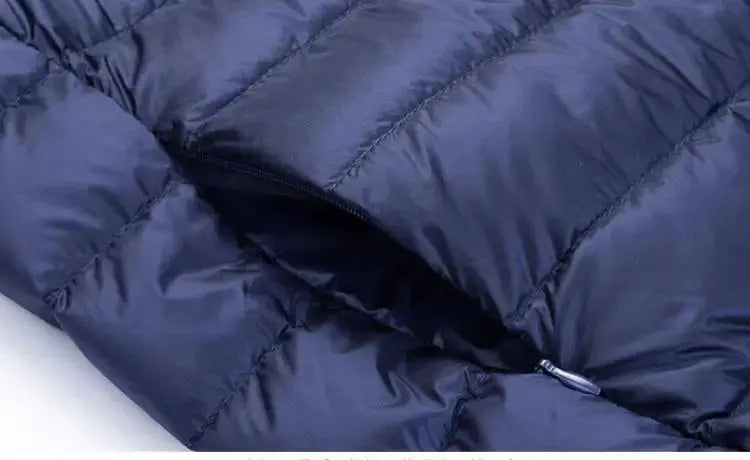 UETEEY men's down jacket, navy blue quilted puffer with front zipper.