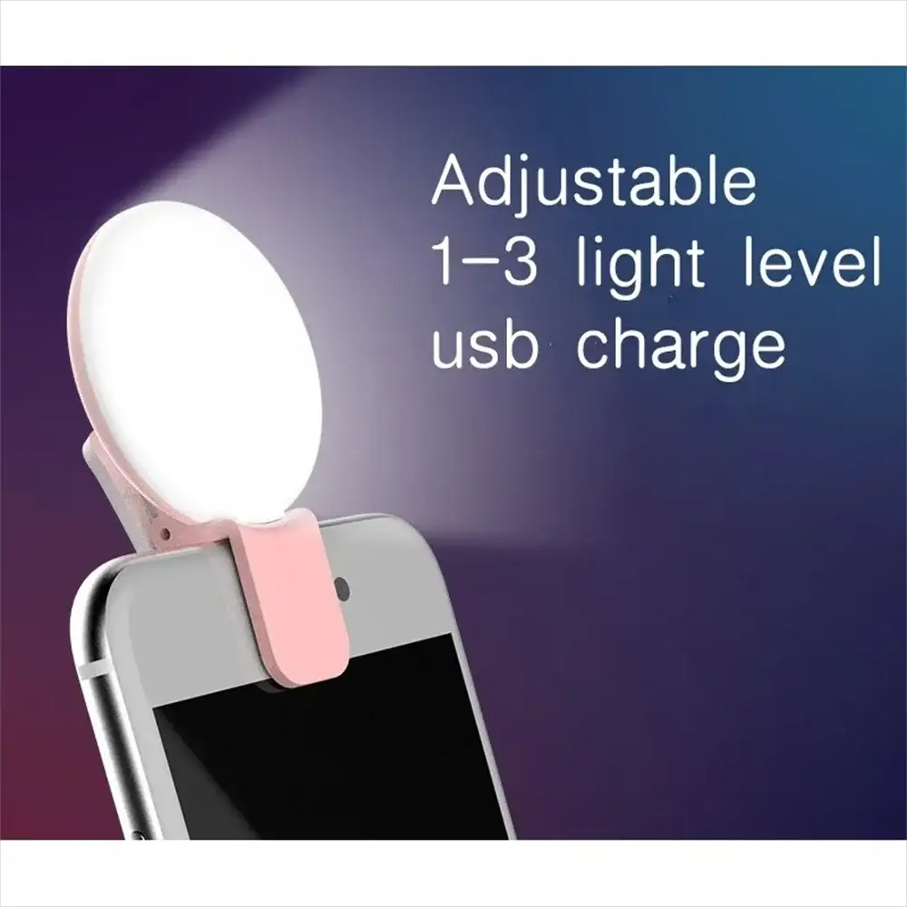 Portable LED selfie light with pink clip for smartphones; adjustable 1–3 brightness levels via USB.