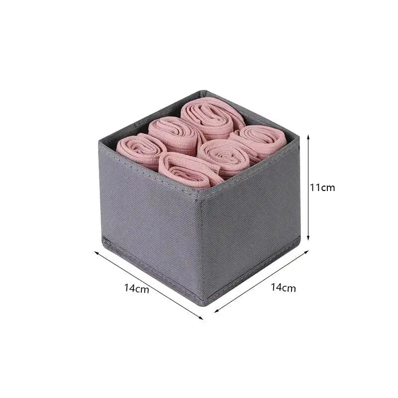 Gray fabric foldable drawer organizer box, 14x14x11 cm, with six pink rolled socks inside.