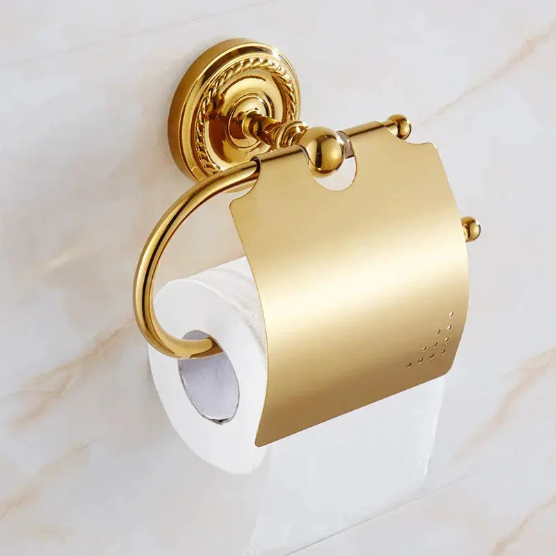 Gold brass bathroom accessories set by Simples Market: toilet paper holder and towel ring with ornate backplate
