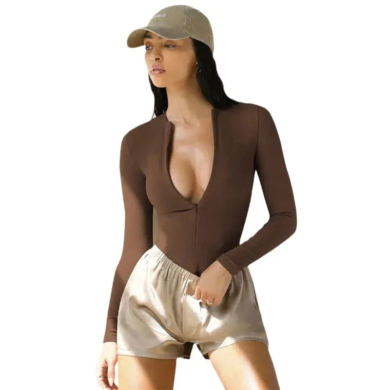 Jumpsuit in brown ribbed knit with long sleeves and plunging zipper neckline.