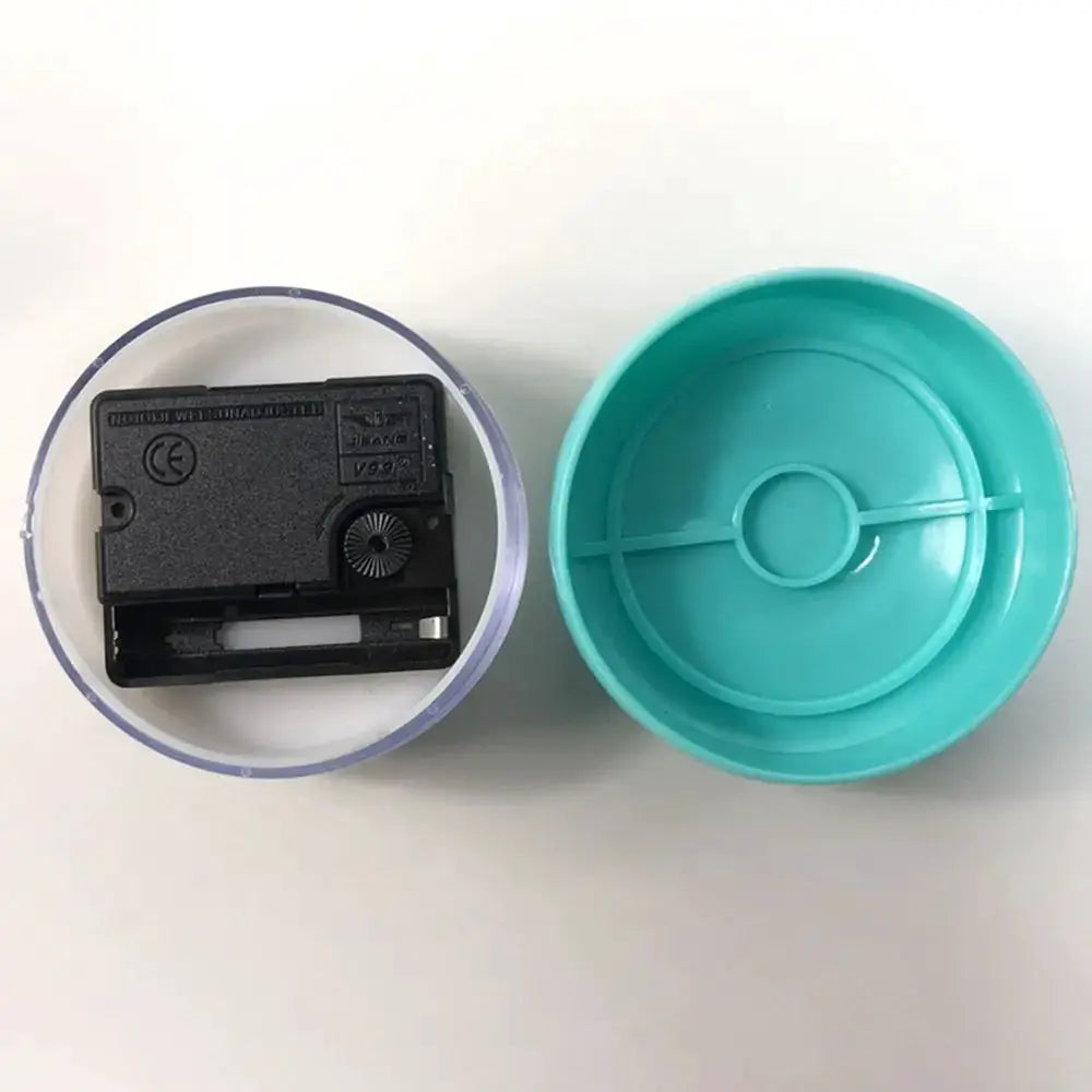 Mini suction wall clock with turquoise shell and visible quartz movement