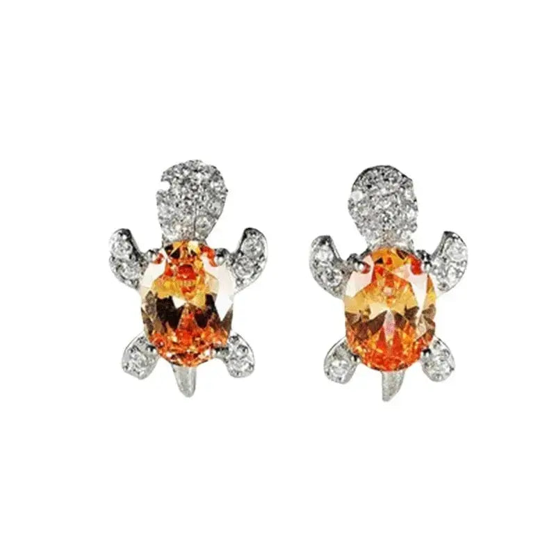 Pair of turtle-shaped silver-plated earrings with orange oval glass stones and clear crystal accents