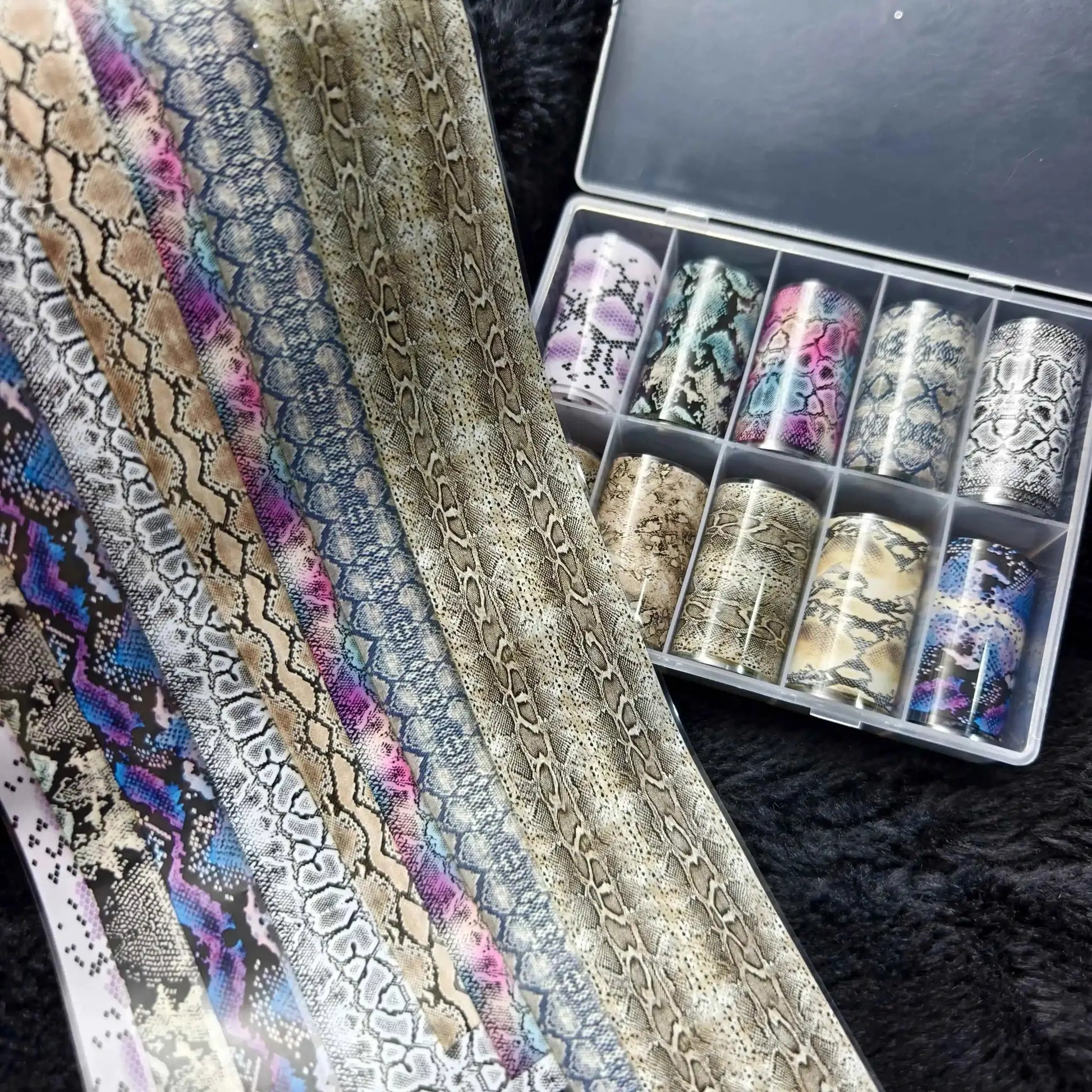 Nail foil rolls set, 10 pieces, featuring snake-skin patterns in beige, blue, pink, and taupe in a clear storage case