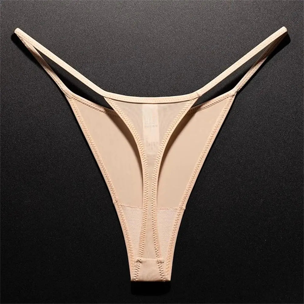 Nude high-cut thong underwear with seamless panels on dark background