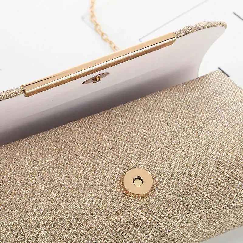 Gold sequined clutch bag with chain strap for women's evening wear; magnetic snap closure
