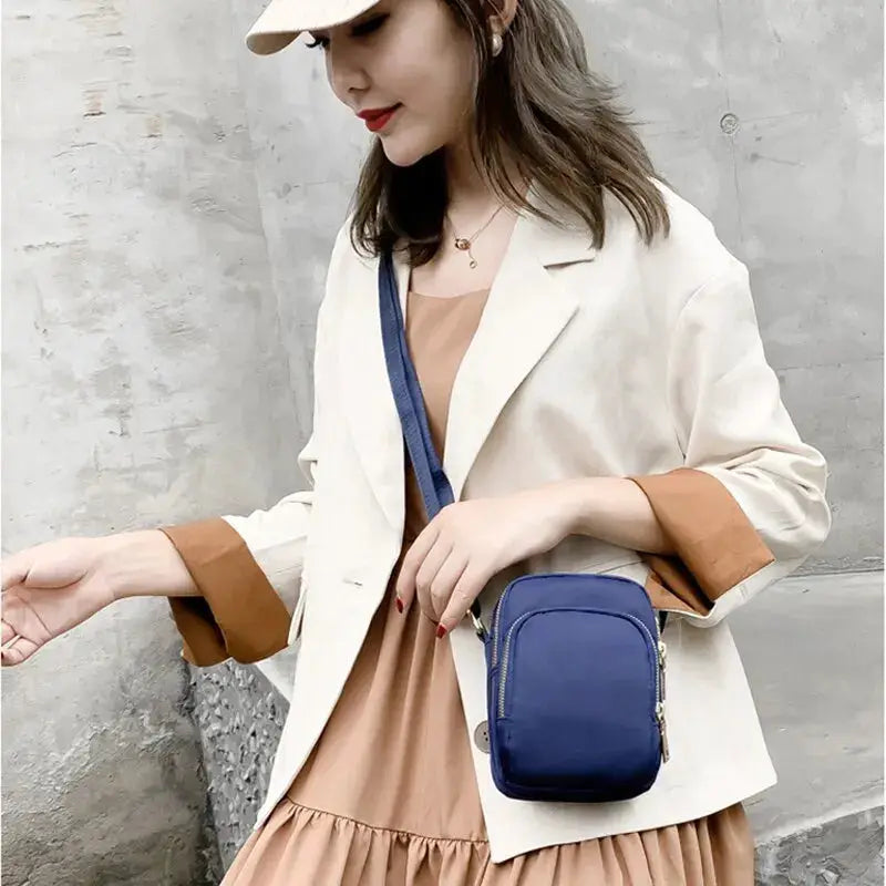 Women crossbody bag by Simples Market; blue compact handbag with zipper pocket