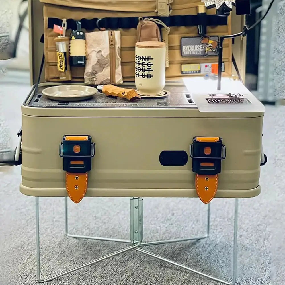 Folding plastic cooler box stand in tan with orange leather strap latches, portable for outdoor camping and picnics.