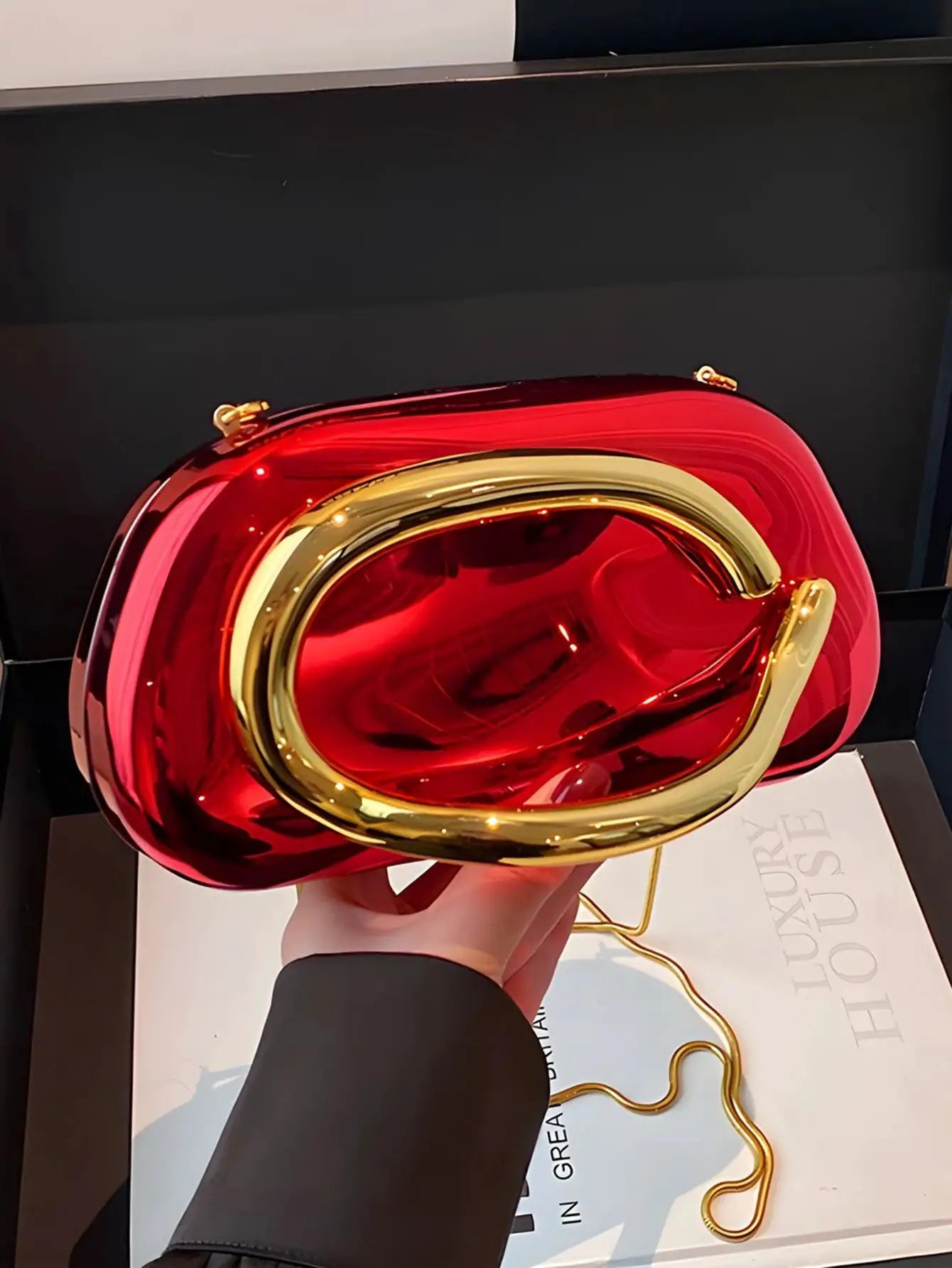 Acrylic box crossbody bag, red translucent body with gold-tone frame and chain strap