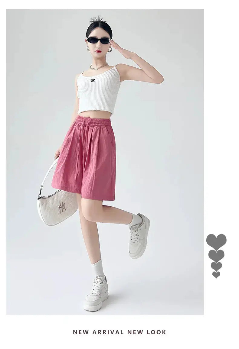 Women’s pink high-waist shorts with two pockets and elastic waistband.