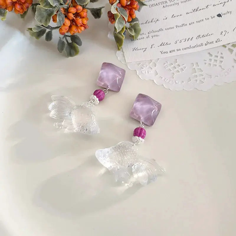 Simples Market Creative transparent goldfish pendant earrings with lilac cube beads, pair