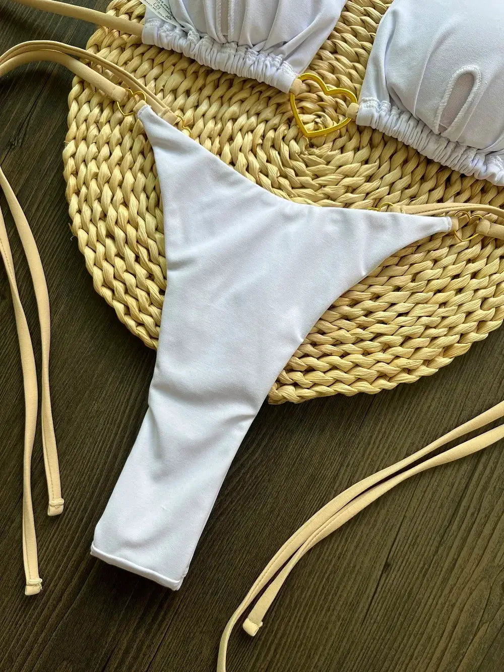 Bikini set two-piece light blue solid color with triangle thong bottoms and halter top on a woven straw mat