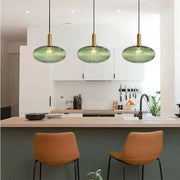 Nordic glass pendant lights, three green fixtures by Simples Market over a kitchen island (E27).
