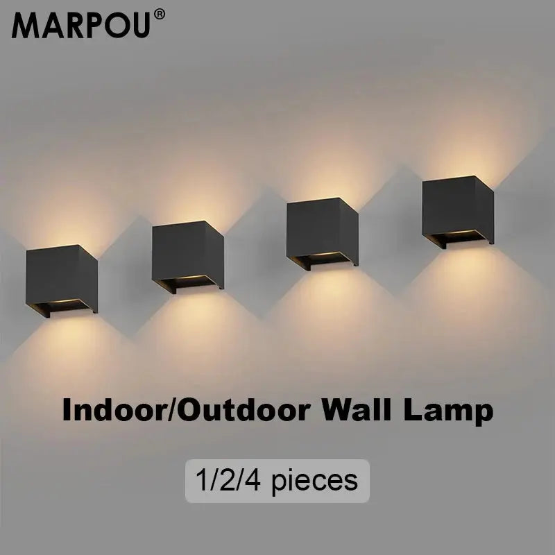 MARPOU four black cube LED wall lamps mounted in a row with warm ambient lighting; indoor/outdoor wall light set.