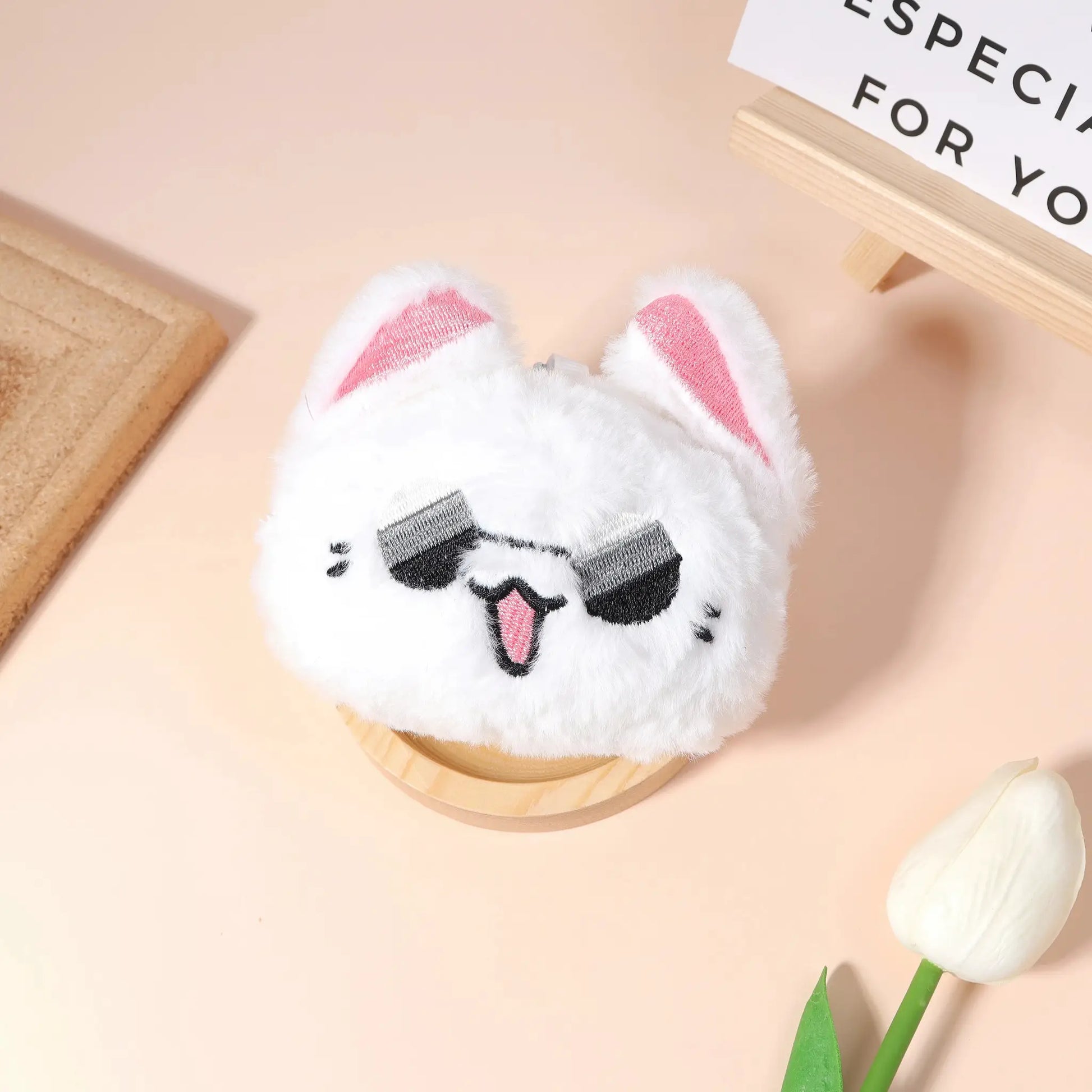 Anime plush keychain featuring a white fluffy character with pink inner ears and black stitched eyes