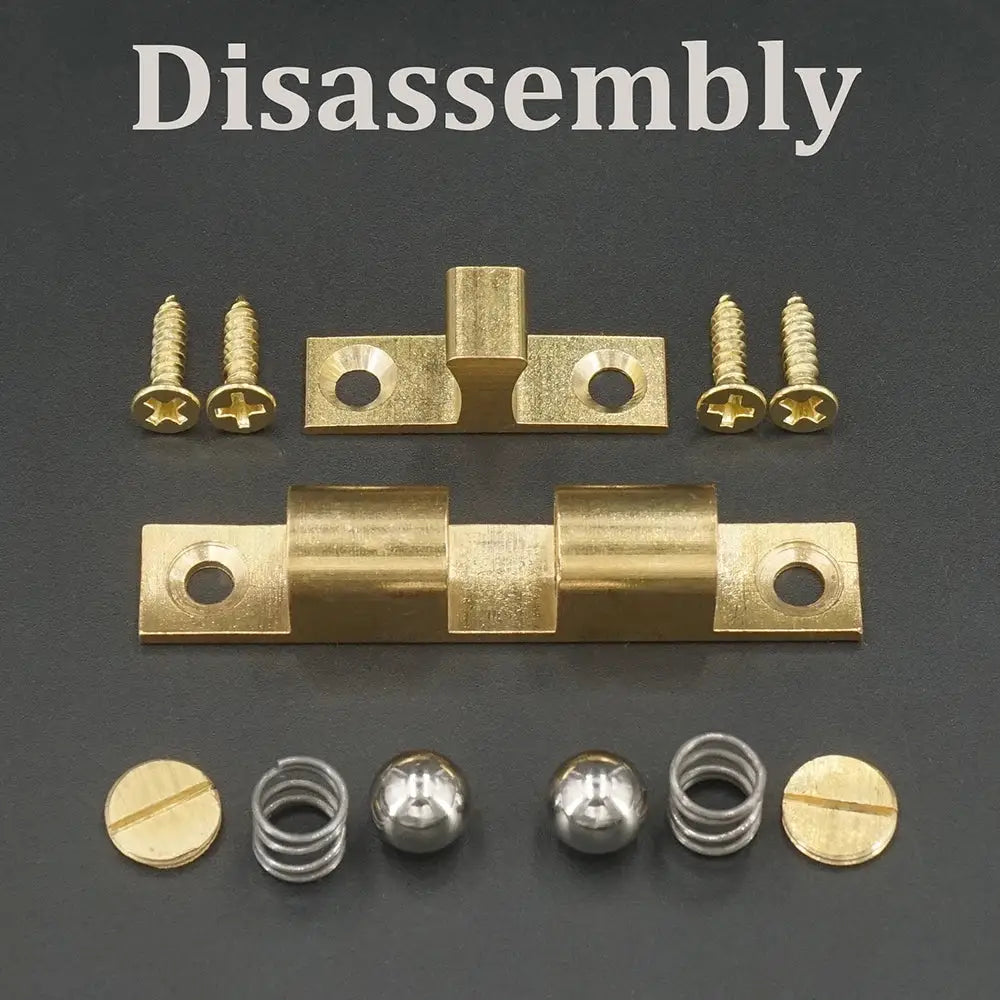 Cabinet door latch hardware set in solid brass, disassembled with screws, springs, and caps