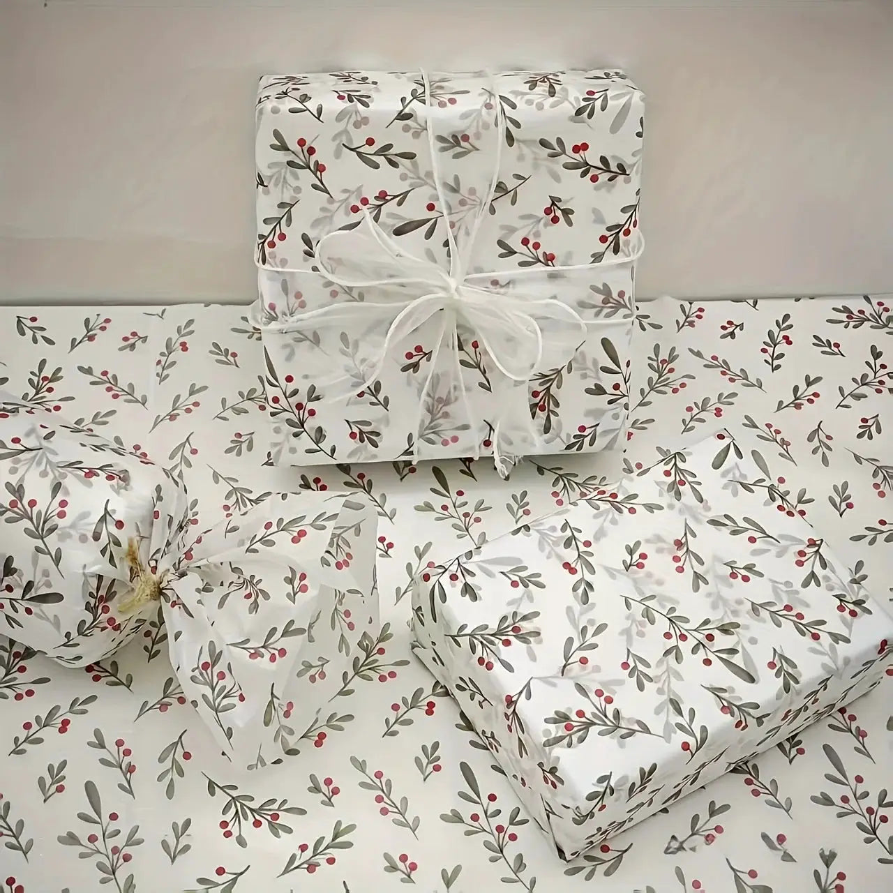 Holly berry gift wrap sheets; white wax-coated thin paper bundled with a white ribbon